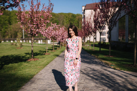 Elegant woman in beautiful dress stand outside. Gorgeous model w