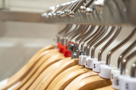 Close up clothes hangers on rack. Background for fashion retail 