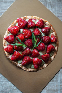 Strawberry cake on a wooden background. 