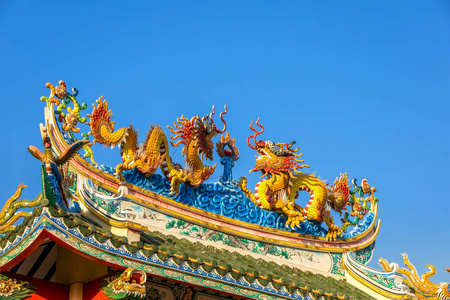 Beautiful Elegant double golden dragon statue on the roof of on 