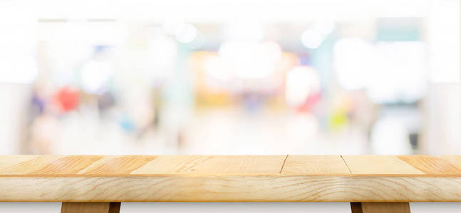 Empty wood table top with blur department store boekh background