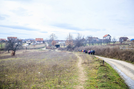  active people trekking on rural landscape