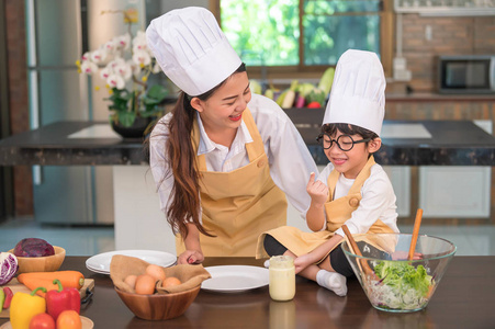 Happy beautiful Asian woman and cute little boy with eyeglasses 