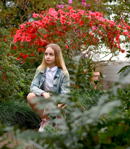 young girl with long white hair and a denim jacket 