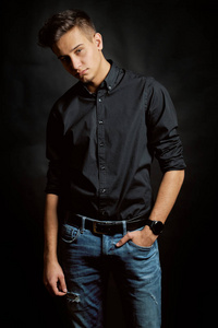 Fashion portrait of young man in shirt on black background 