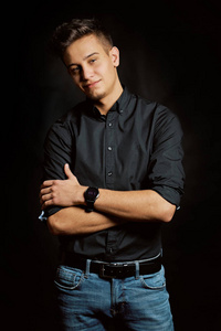 Fashion portrait of young man in shirt on black background 