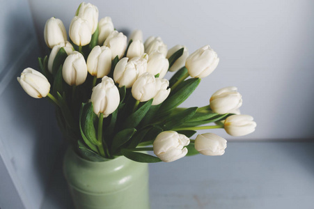  Fresh pink tulip flowers bouquet on shelf in front of stone wal