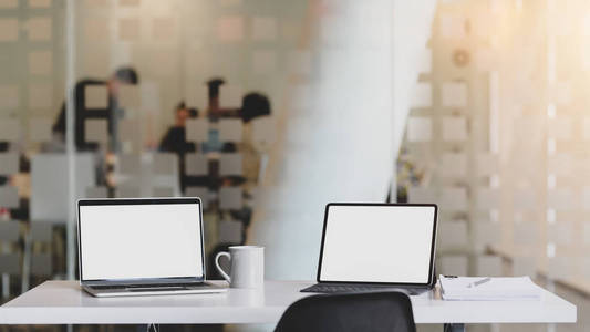 Cropped shot of workplace with blank screen tablet, laptop, offi