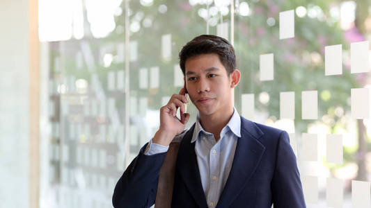 Close up view of young professional businessman talking on his s