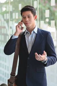 Close up view of  businessman talking on his smartphone in blurr