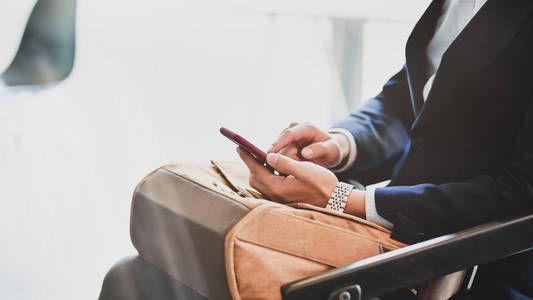 Cropped shot of young professional businessman using smartphone 