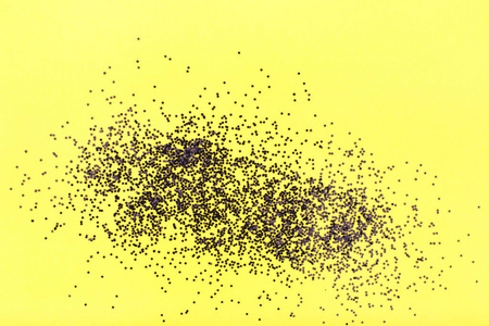 Yellow background with black confetti. 