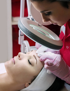 Beautiful young woman  having face cleaning. 