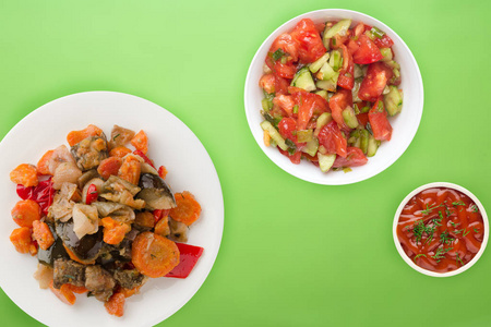 vegetable stew on a white plate. stewed vegetables on a colored 