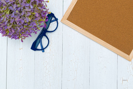 Empty cork board with little tree on wooden desk