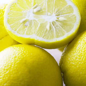 一块丑陋的双有机柠檬形状奇特,周围有许多水果.闭合.