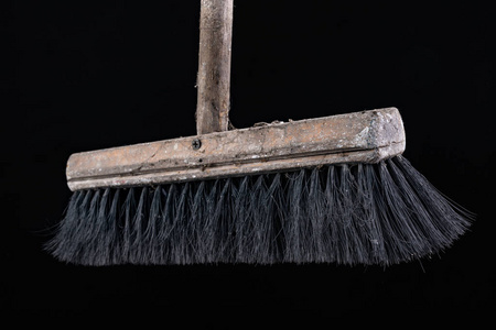 Old dusty wooden broom. Cleaning accessories. 