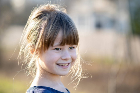 Portrait of a pretty child girl outdoors on a sunny warm autumn 