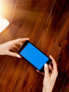 Close up photo of female hands holding smartphone horizontally. 