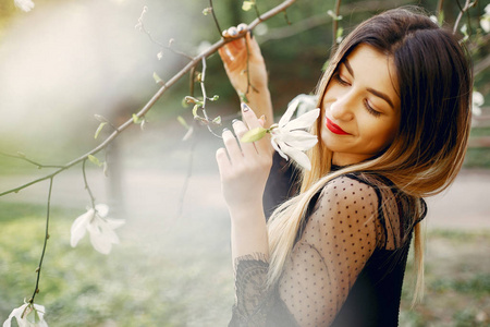 Elegant little girl in a spring park