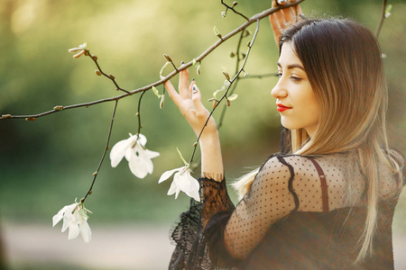 Elegant little girl in a spring park