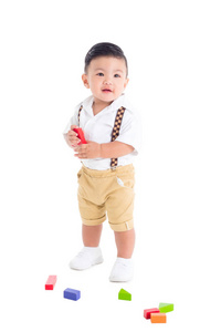 Little asian male toddler standing and smiles 