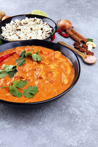 Chicken tikka masala spicy curry meat food in pot with rice and 