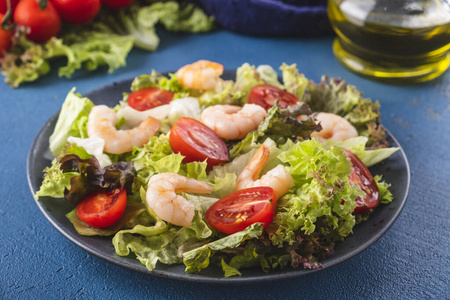 Delicious seafood salad with shrimps and fresh vegetable salad. 