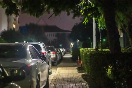 a nice looking narrow night shoot from sidewalk  there is many 