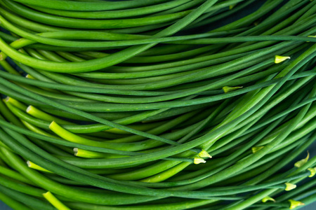 Fresh green healthy vegetables On green wooden plate  