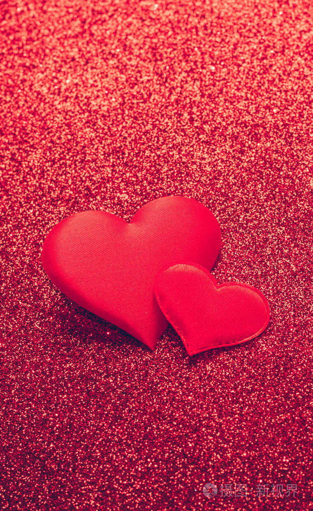 两颗红心象征着爱在闪亮的背景上情人节概念垂直框架复制空间