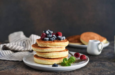 Beautiful pancakes with berries and sauce 