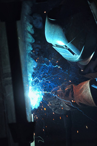 Worker With Protective Mask Welding 