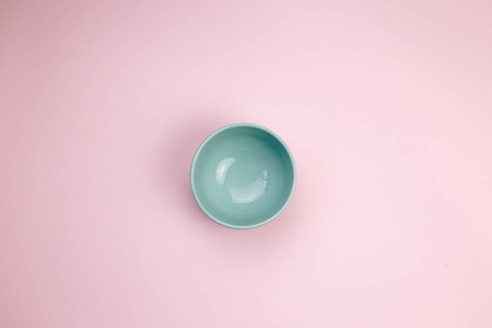  empty blue bowl on pink background