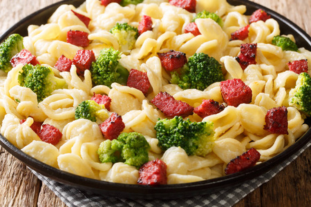 Tasty pasta orecchiette with broccoli and grilled sausages in a 