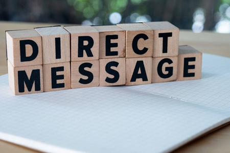 Direct Message word written on wood block. 