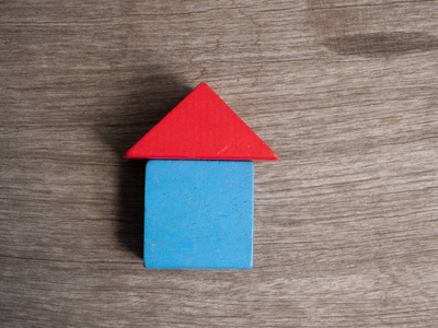 Wooden house toy with wood background 