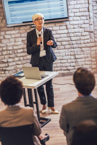 Speaker giving a talk in conference hall at business event. 