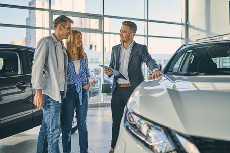 Dealer in business suit demonstrating the details of purchasing 