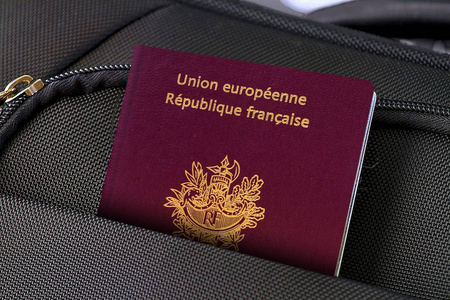 Close up of France Passport in Black Suitcase Pocket 