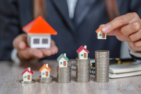 miniature houses among pile of coins, Housing industry mortgage 