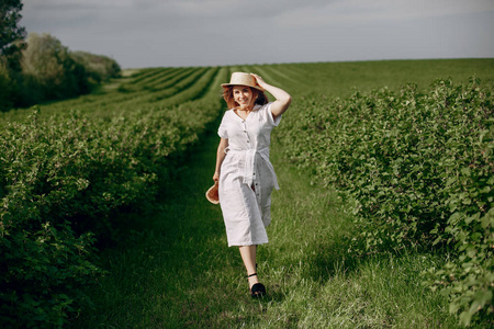 Elegant and stylish girl in a summer field