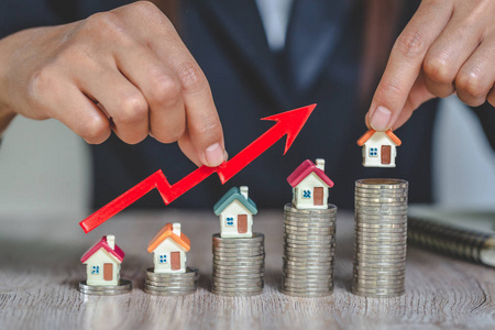 Businessman Holding  Graph Over The Increasing House Miniature, 