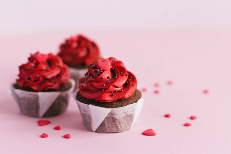 Valentine cupcakes, decorated with sweet hearts on pink pastel b