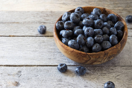 Fresh blueberries in a wooden bowl 