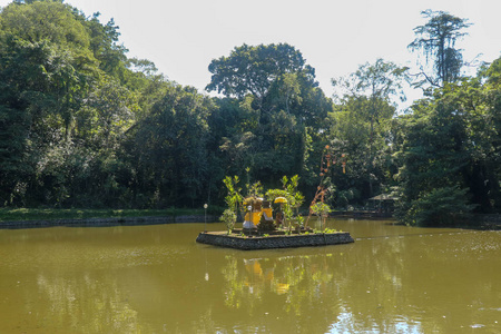 A temple built in the middle of a reservoir. Sculptures wrapped 