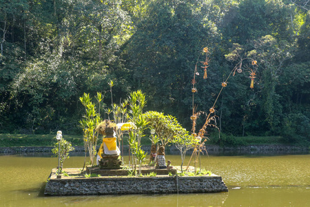 A temple built in the middle of a reservoir. Sculptures wrapped 