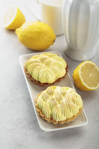 Tartlets with lemon cream on a white table. 