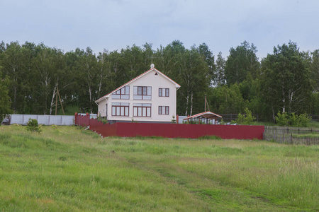 Modern village house in a meadow 