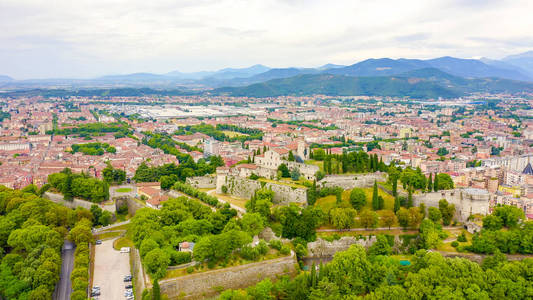 Brescia, Italy. Castello di Brescia. Flight over the city in clo